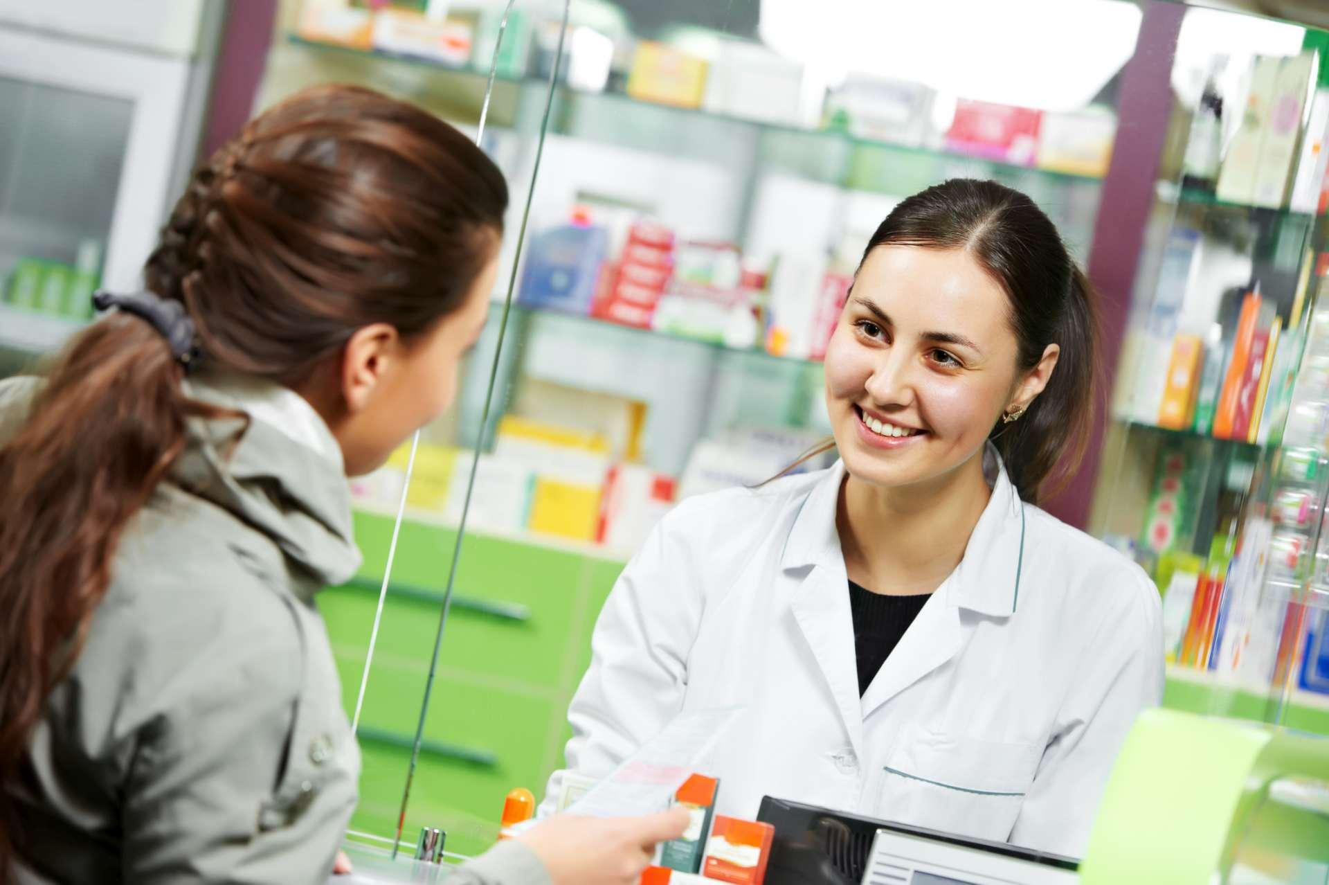 pharmacist suggesting medical drug to buyer in pharmacy drugstore