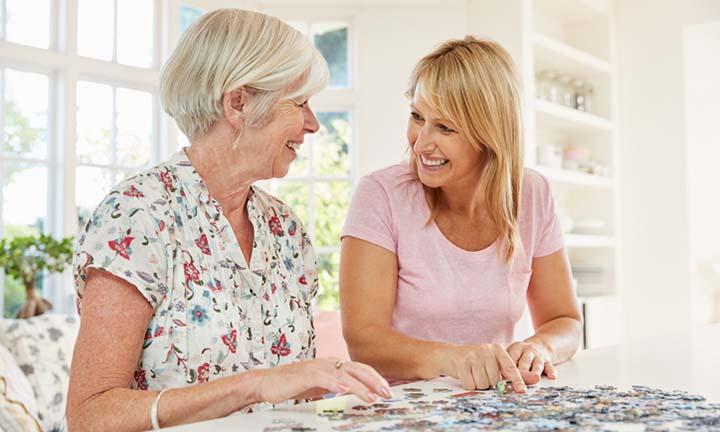 Senior couple doing a jigsaw puzzle at home